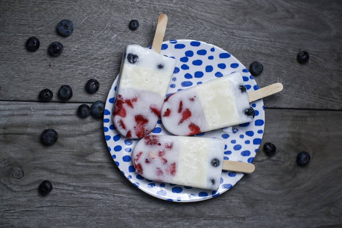 3 Red White and Blue Keto Creamsicle Popsicles on a plate