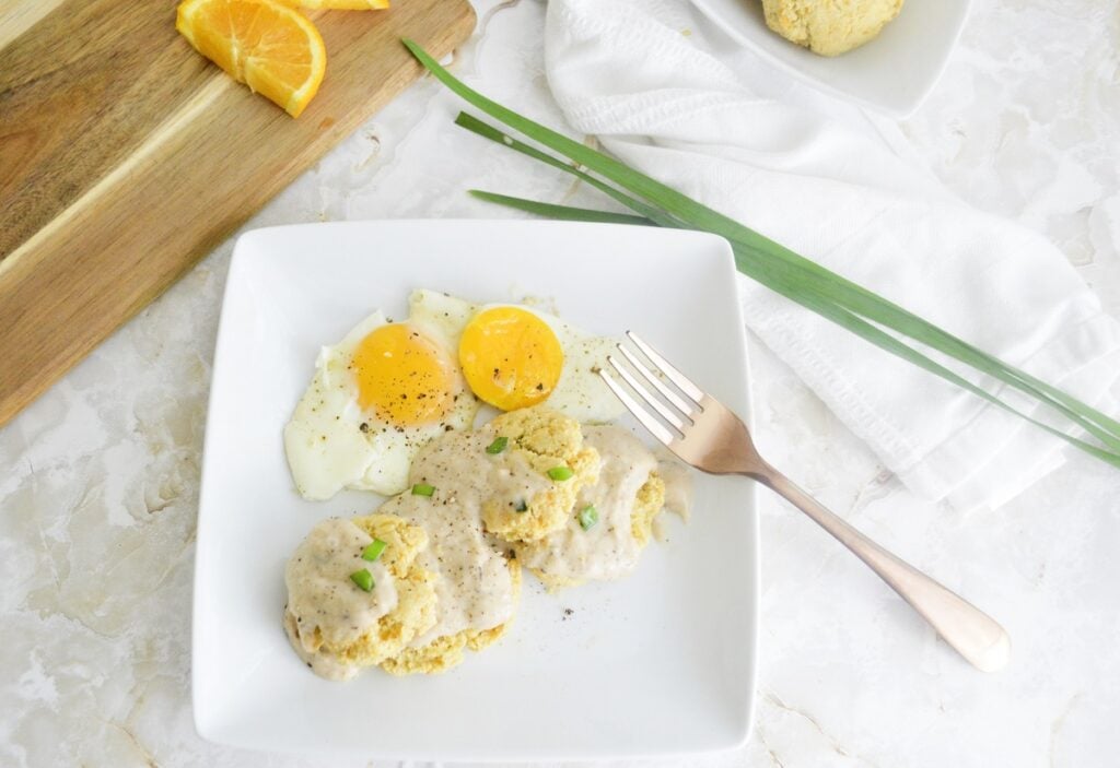 Keto Biscuits and Gravy on white plate with egg