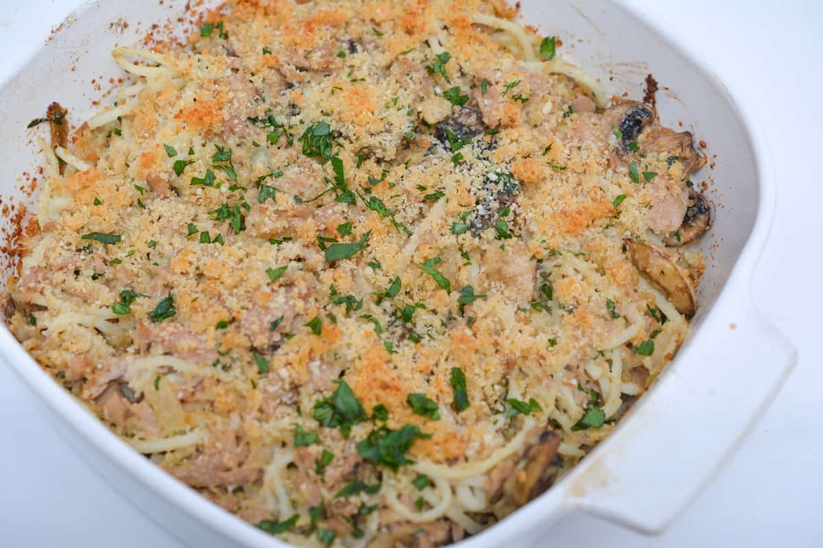 Closeup of Keto Tuna Noodle Casserole in a white square baking dish, baked till golden brown and ready to be served.
