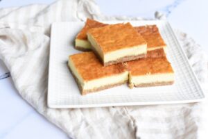 Five Carnivore Dessert Bars on a white square plate, all placed on a light-colored cloth.