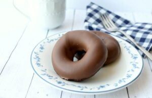 Chocolate Donuts on a white plate with milk.