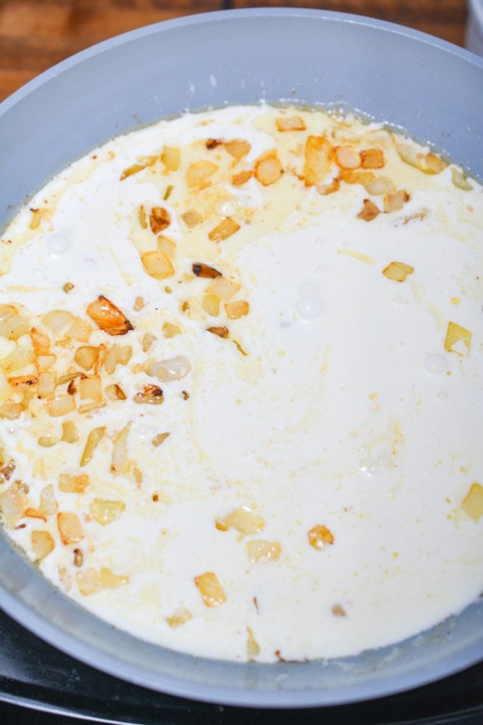 Onions and cream in a pan.