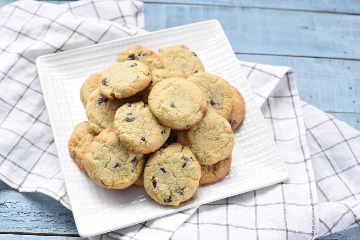 Chocolate chip cookies on a white plate.