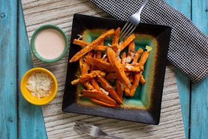 Air Fryer Sweet Potatoes on a plate with sauce.