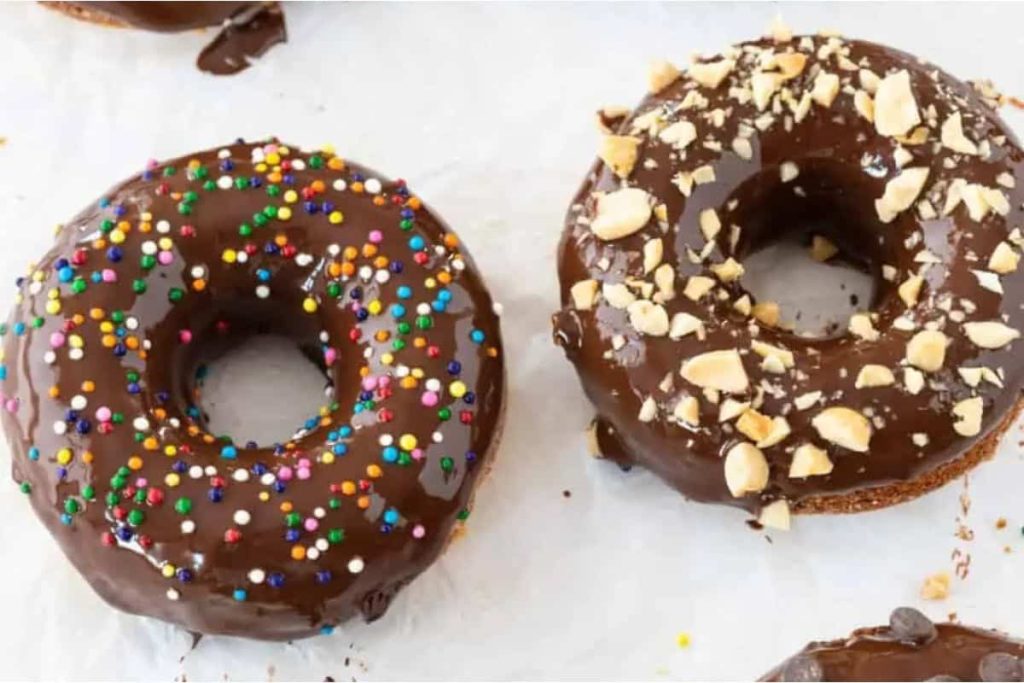 Chocolate Chip Donuts with Chocolate Ganache on a white board.