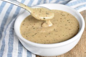 Peppered Gravy with a spoon scooping it.