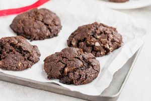 German chocolate cookies on white parchment paper.