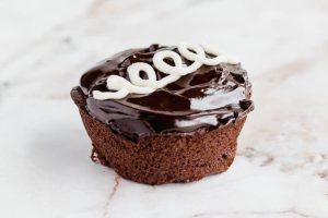 A keto hostess cupcake on a white board.