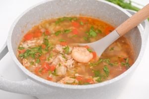 Crab and shrimp gumbo in a bowl with a spoon.