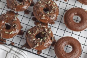Chocolate Mint Donuts on a wire rack.