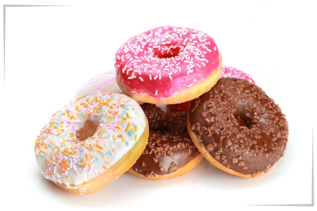 4 colorful donuts on a plate.