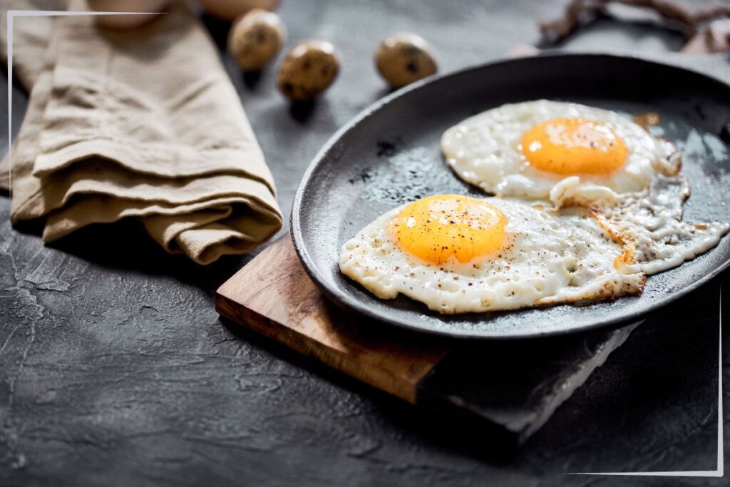 A skillet with two sunny side up eggs.