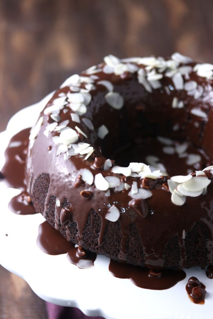 A keto chocolate bundt cake on a white plate.