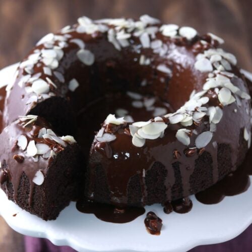 A keto chocolate bundt cake on a white plate.