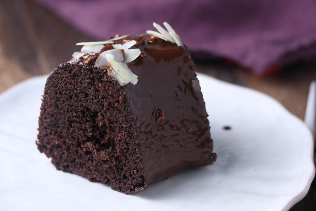 A keto chocolate bundt cake on a white plate.