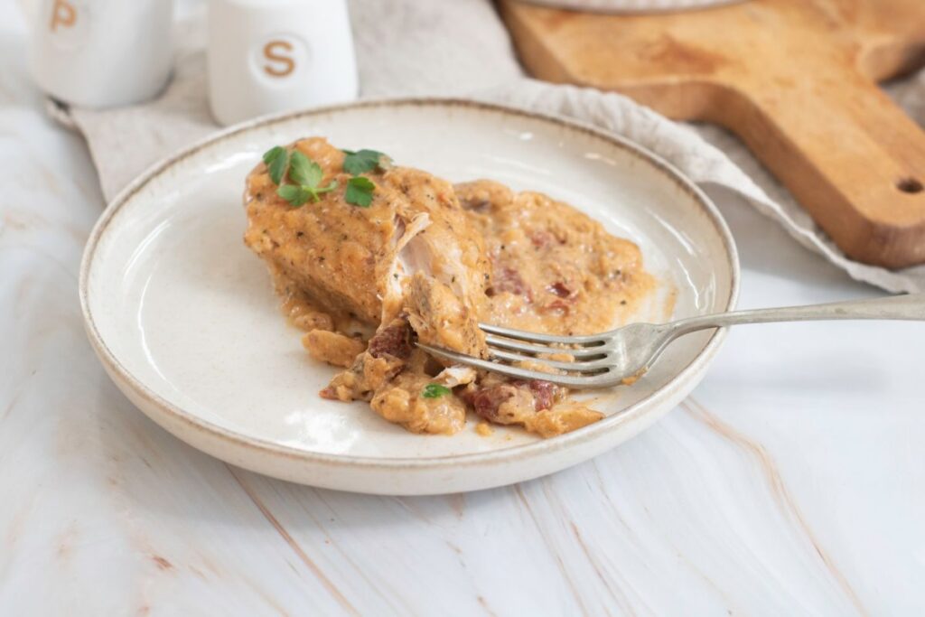 A bowl of Marry Me Chicken on a white plate.