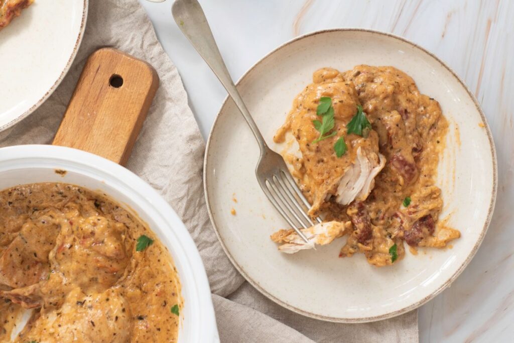 A bowl of Marry Me Chicken on a white plate.
