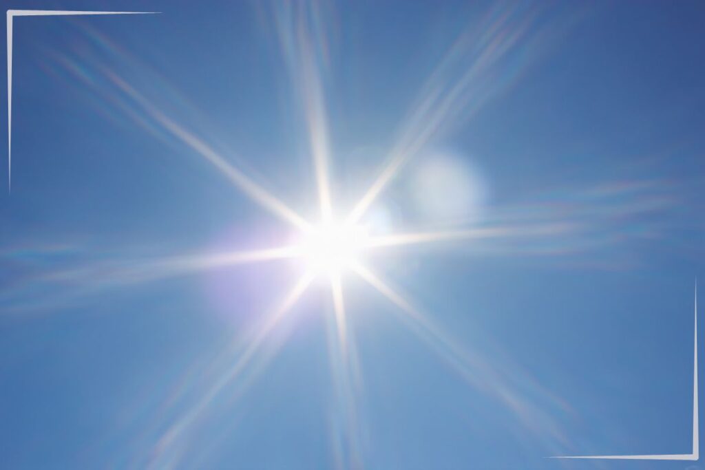 A bright sun in the blue sky.