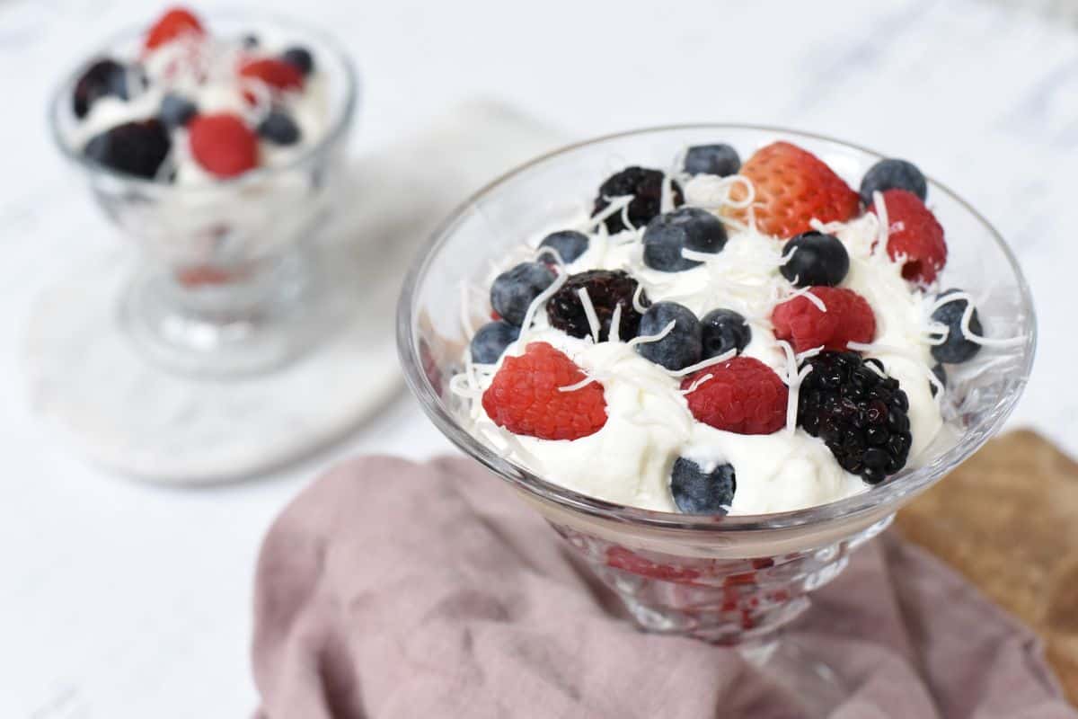 Berries with Amaretto Cream in serving dishes.