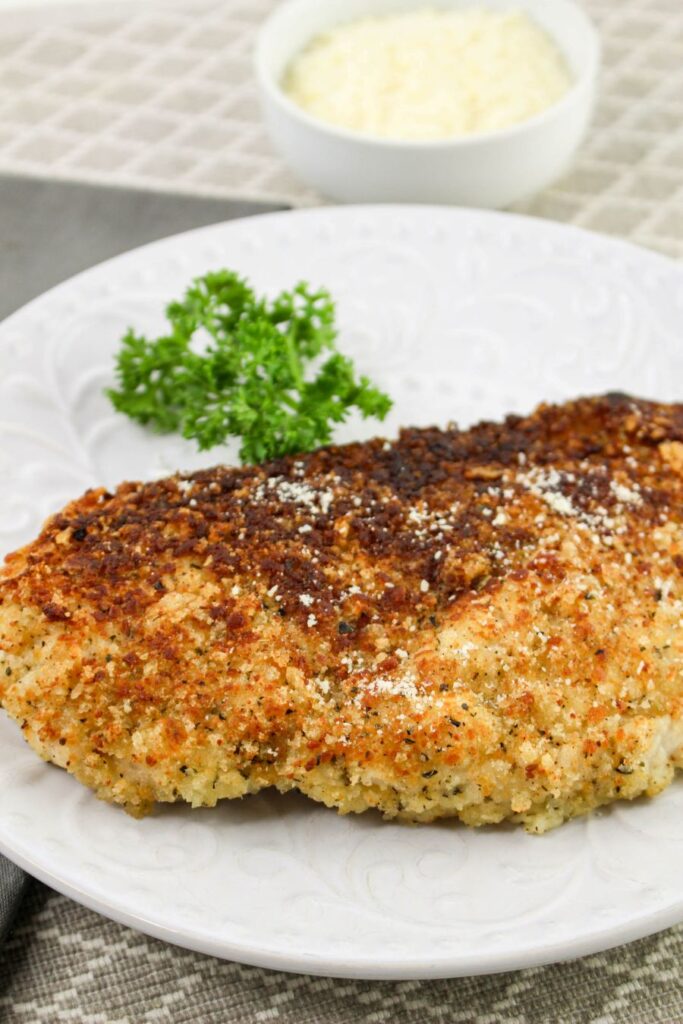 Crusted Chicken Romano on a white plate.