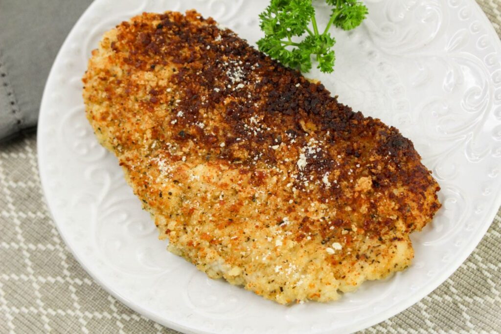 Crusted Chicken Romano on a white plate.