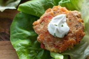 A Keto Tuna Cake on a piece of lettuce, close up.