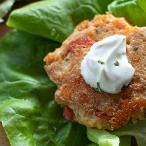 A Keto Tuna Cake on a piece of lettuce, close up.