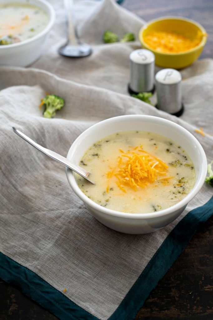 A bowl of Low Carb Broccoli and Cheese Soup With Chicken and a spoon.